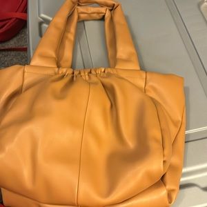 Tan puffy , a new day purse